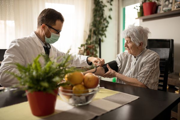 nurse checking a patient's blood pressure
