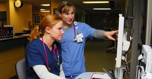 2 Nurses checking charts