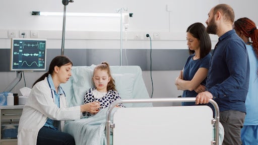 a family nurse practitioner explaining her treatment plan to a young patient in hospital