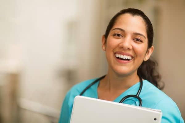 Smiling nurse in green scrubs