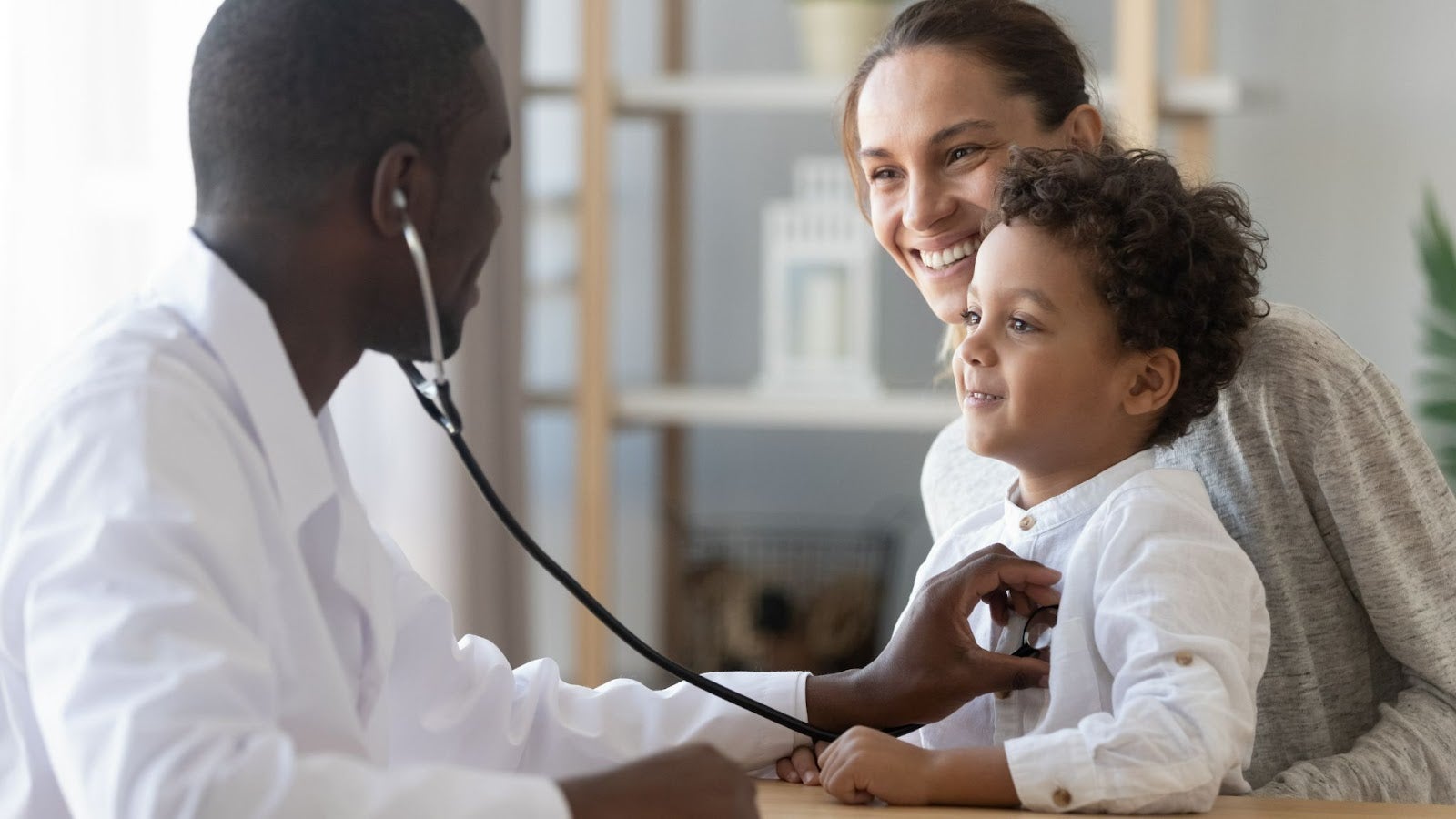 Family Nurse Practitioner listens to heartbeat of a child patient through stethoscope