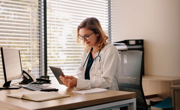 Family nurse practitioner leading a telehealth appointment in her office