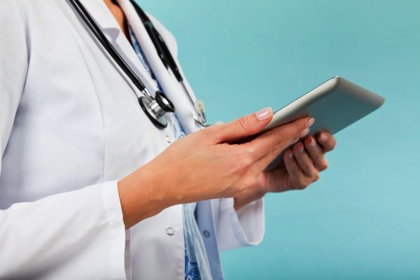 Family nurse practitioner holding a tablet device