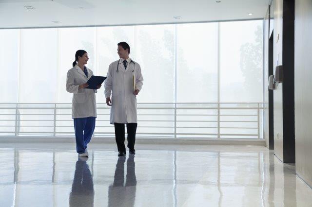 doctor walking with nurse in hospital hallway