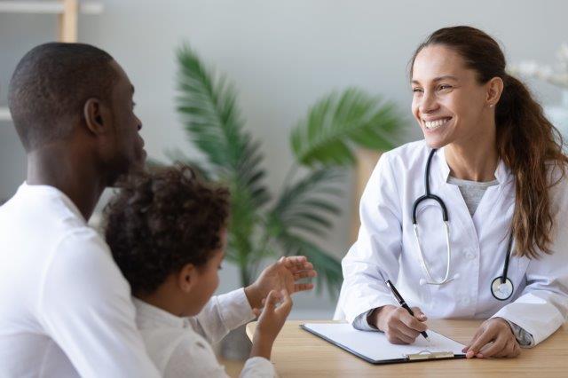 smiling nurse talks to patients