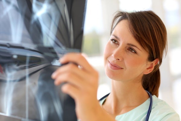 Female nurse practitioner examining a set of X-rays