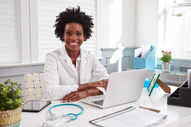 Smiling nurse at desk