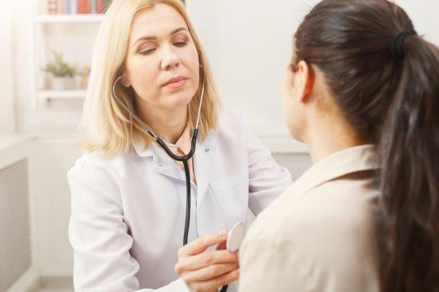 Nurse taking vitals of a patient