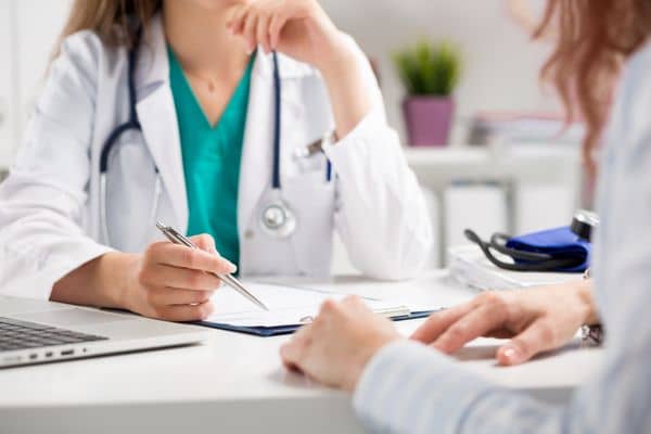 Female nurse practitioner meeting with her patient in office setting