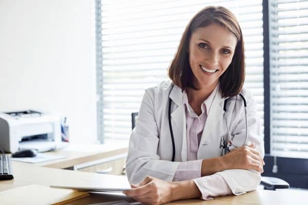 Confident female family nurse practitioner in office setting