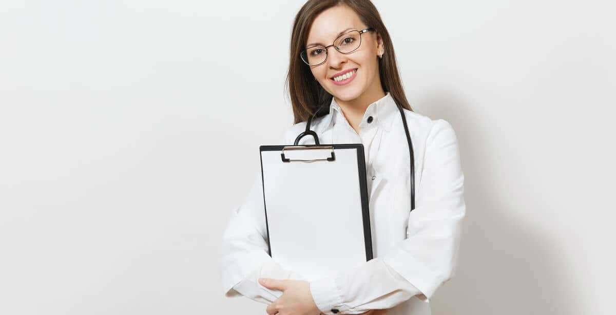 Confident nurse practitioner in white lab coat holding clipboard