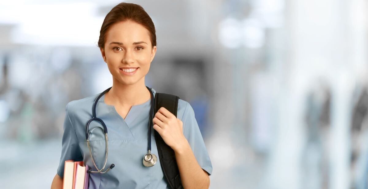Nurse student wearing a backpack and carrying books